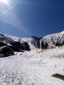Una montaña cubierta de nieve con gente en una pista de esquí. en 201, Les Ambassadeurs, en La Bourboule 6 fotos más