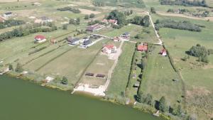 an aerial view of a house on an island in the water at Nad Sunowem Lake House in Chrzanowo