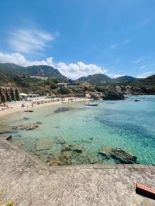 a beach with a group of people in the water at Ciao Iglesias 3 in Iglesias