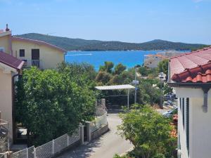 a street in a town with a view of the ocean at Cozy Designed & Sea view Apartment SULYE, Zaboric Sibenik in Zaboric