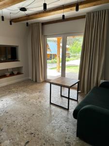 a living room with a couch and a coffee table at Domki Sosnówka in Majdan Sopocki