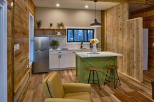 a kitchen with a green island and a refrigerator at Serenity Barn in Mooresville