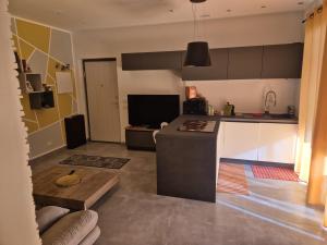 a kitchen and living room with a counter and a table at Tuscia Rooms dei Papi in Viterbo
