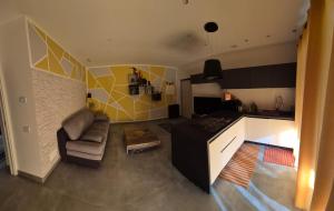 a living room with a couch and a kitchen at Tuscia Rooms dei Papi in Viterbo