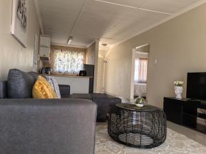 a living room with a couch and a table at SinoT Short Stays in Pietermaritzburg