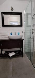 a bathroom with a sink and a mirror at Domek na Błotach in Karwieńskie Błoto Drugie