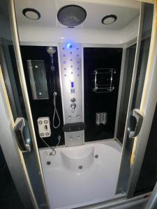 a small bathroom with a shower and a sink at Private villa suitable for families with stunning sea views in Buyukcekmece