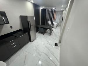 a living room with a refrigerator and a table at Design Loft - Near Copacabana Palace Hotel and Copacabana Beach in Rio de Janeiro +29 photos