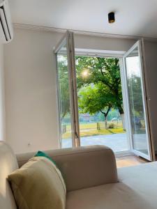 a room with a couch in front of a sliding glass door at Hacienda DM in Visoko +36 photos
