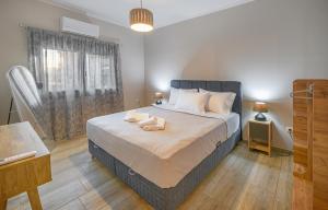 a bedroom with a bed with two towels on it at Hara Apartments in Chrysoupolis