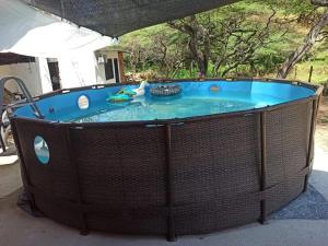 a hot tub with a wicker fence around it at Cabañas Spacetatacoa in Villavieja