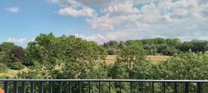a balcony with a view of a field and trees at Hotelapartment Meerliebe in Cuxhaven +1 photo