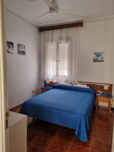Postel nebo postele na pokoji v ubytování Casa de Huéspedes Cuenca
