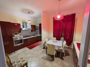 a kitchen with a table and a dining room at La casa di Cisotta in Fivizzano