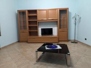 a living room with a tv and a coffee table at La casa di Cisotta in Fivizzano