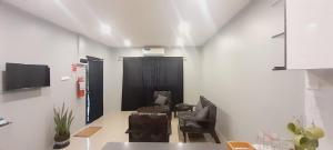 a living room with two chairs and a television at Prasad Apartments in Labasa