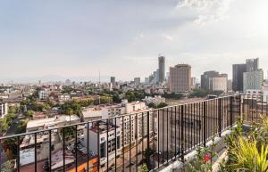 a view of the city from the balcony of a building at Kukun Reforma & Downtown in Mexico City