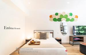 a bedroom with a large bed and a mirror at Kukun Reforma & Downtown in Mexico City