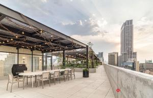 a rooftop patio with tables and chairs on a building at Kukun Reforma & Downtown in Mexico City
