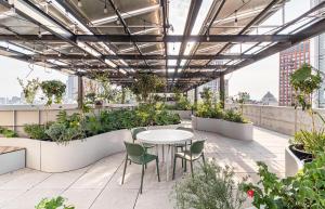 a patio with a table and chairs and plants at Kukun Reforma & Downtown in Mexico City