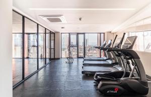 a row of treadmills in a gym with windows at Kukun Reforma & Downtown in Mexico City