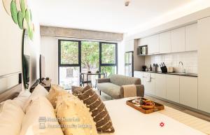a living room with a couch and a kitchen at Kukun Reforma & Downtown in Mexico City