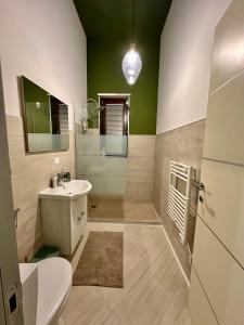 a bathroom with a sink and a toilet and a mirror at Chicco di Grano in Locorotondo +26 photos