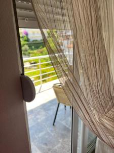 a door with a curtain open to a balcony at Apartmani Juković in Ulcinj