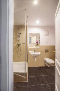 a bathroom with a shower and a sink and a toilet at Hotel Storchen in Ravensburg