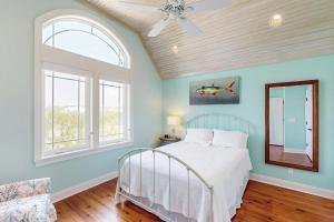 a bedroom with a bed and a ceiling fan at Sweet Carolina in Edisto Island
