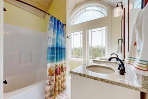 a bathroom with a sink and a shower at Sweet Carolina in Edisto Island +17 photos