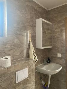 a bathroom with a sink and a mirror at Apartman Green Vlašić in Šišava +36 photos
