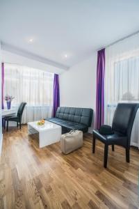 a living room with a couch and two chairs at Hotel Storchen in Ravensburg