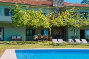 a house with a swimming pool in front of a house at Just Like Home - Casa de Cimo de Vila in Vila Nova de Cerveira +49 photos