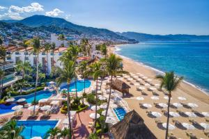 an aerial view of a beach with umbrellas and the ocean at Buenaventura Grand Hotel & Great Moments - All Inclusive in Puerto Vallarta