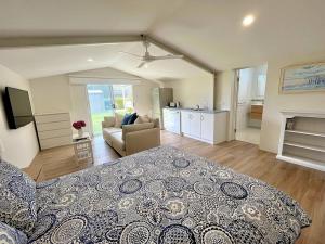 a large bedroom with a bed and a living room at Rose Villa - Port Willunga in Port Willunga