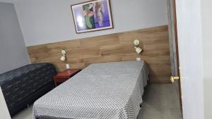 a room with a table and a black couch and a table at Hotel Luupi Esmeralda Apto 159 - Rio Quente GO in Rio Quente