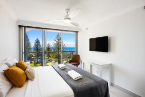 a bedroom with a large bed with a large window at Peninsula Apartments managed by Gchs in Gold Coast +215 photos
