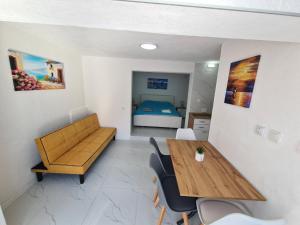 a room with a table and a couch and a bed at Sunny Lake Trpejca in Ohrid