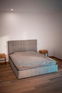 a large bed in a room with two tables at Banya Villa Bucuresti sauna jacuzzi piscina spa in Gulia +33 photos