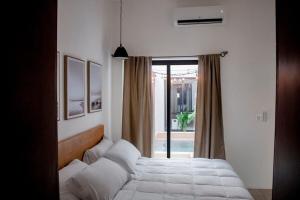 a bedroom with a bed and a window at Casa 59, con alberca en el centro in Campeche +23 photos