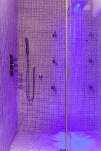 a bathroom with a shower with purple lighting at Hotel Villa Margherita in Golfo Aranci
