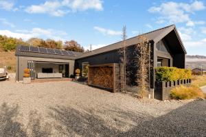 a house with solar panels on the side of it at Anaka in Wanaka