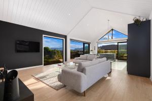 a living room with a couch and a table at Anaka in Wanaka