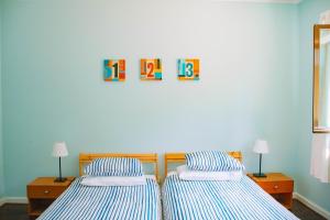 two beds sitting next to each other in a room at Just Like Home - Casa de Cimo de Vila in Vila Nova de Cerveira
