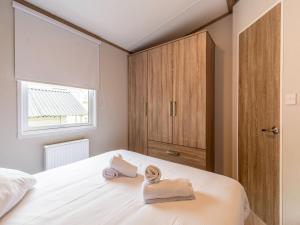 a bedroom with a bed with towels on it at Chalet in De Haan near Sandy Beaches in De Haan
