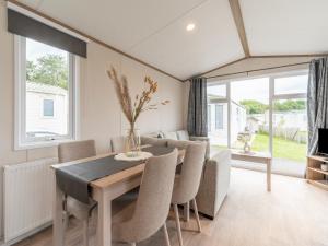 a dining room with a table and chairs at Chalet in De Haan near Sandy Beaches in De Haan