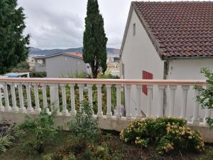 a white house with a fence and a tree at Villa Delfin 4 in Bar