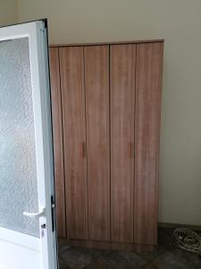 a wooden cabinet in a room next to a door at Villa Delfin 4 in Bar +10 photos