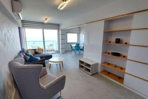 a living room with a couch and a table at Limassol Molos Hawaii Royal - Front-line 2 bedroom in Limassol